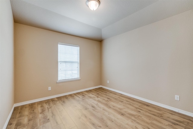 5844 Sunny Meadow Ln, Grand Prairie, TX 75052 - spare room with light wood finished floors, baseboards, and lofted ceiling