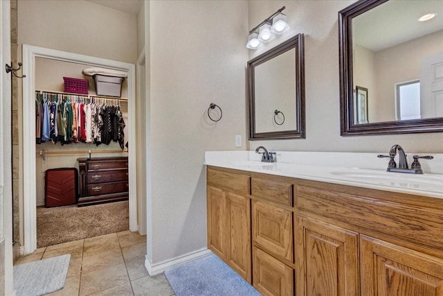 1823 Woodland Park Dr, Denison, TX 75021 - full bath with a spacious closet, double vanity, baseboards, and tile patterned floors