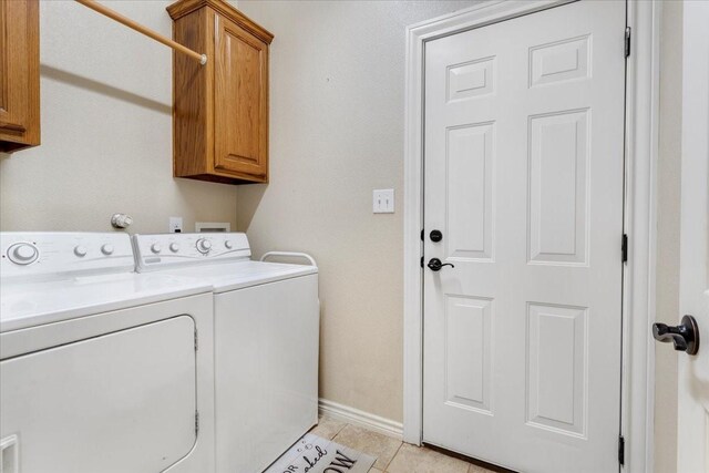 1823 Woodland Park Dr, Denison, TX 75021 - clothes washing area with cabinet space, washing machine and dryer, light tile patterned flooring, and baseboards