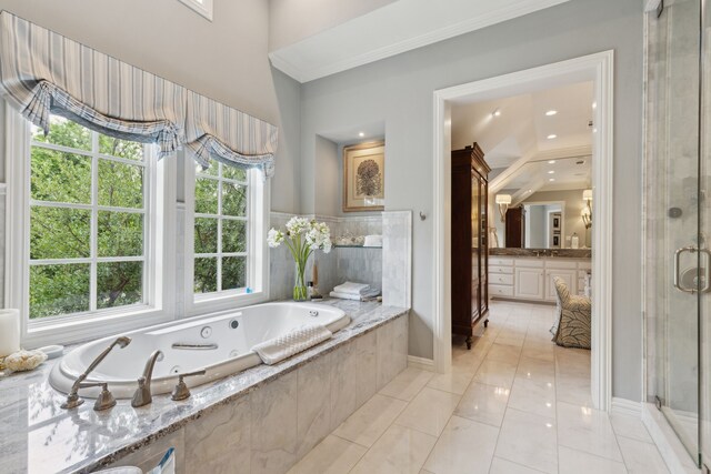 3725 Turtle Creek Blvd Unit A, Dallas, TX 75219 - bathroom with crown molding, a tub with jets, a shower stall, vanity, and baseboards