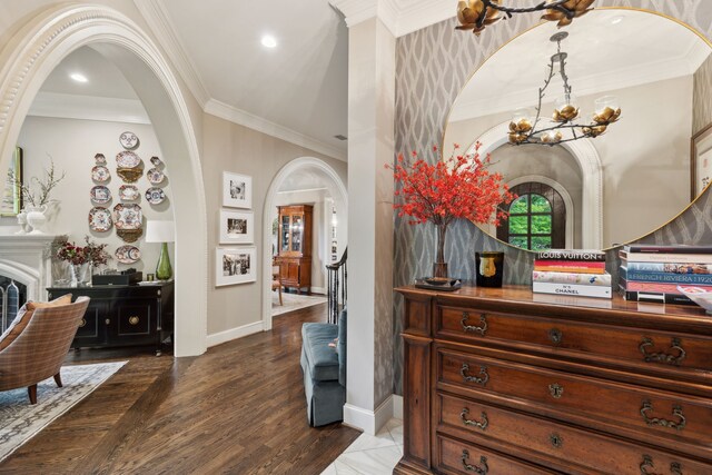 3725 Turtle Creek Blvd Unit A, Dallas, TX 75219 - foyer entrance with a chandelier, arched walkways, baseboards, crown molding, and dark wood-style floors