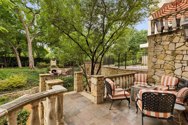 3725 Turtle Creek Blvd Unit A, Dallas, TX 75219 - view of patio / terrace featuring an outdoor fire pit and view of wooded area