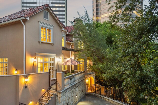 3725 Turtle Creek Blvd Unit A, Dallas, TX 75219 - back of house featuring stucco siding, fence, a gate, and a tile roof