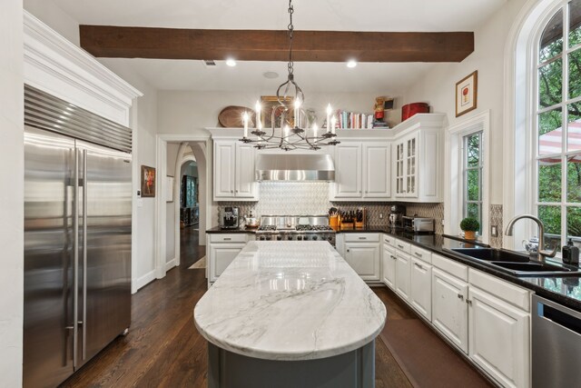3725 Turtle Creek Blvd Unit A, Dallas, TX 75219 - kitchen with appliances with stainless steel finishes, a sink, healthy amount of natural light, a chandelier, and beamed ceiling