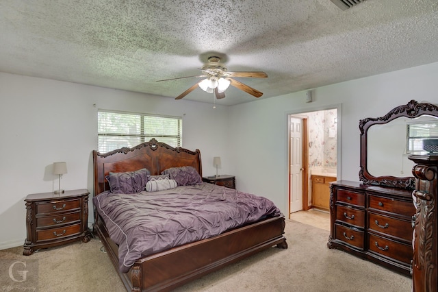 bedroom with light colored carpet, ensuite bath, a textured ceiling, and ceiling fan