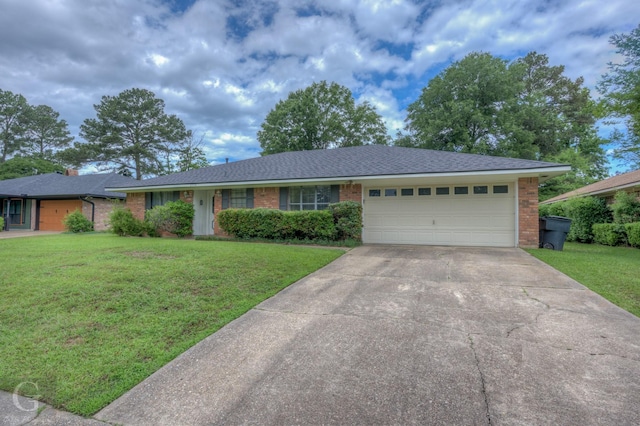 single story home featuring brick siding, driveway, an attached garage, and a front yard