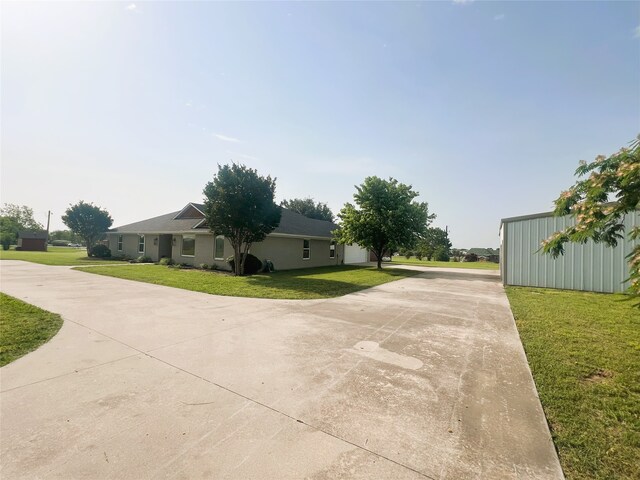 113 County Road 3198, Decatur, TX 76234 - view of side of home with concrete driveway and a lawn