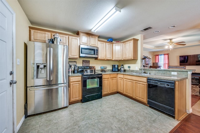 3406 Nomas St, Dallas, TX 75212 - kitchen with black appliances, a sink, a peninsula, light brown cabinetry, and a textured ceiling