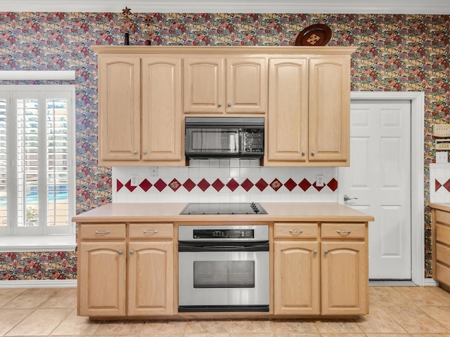 1457 Susan Ln, Carrollton, TX 75007 - kitchen featuring black appliances, light brown cabinets, wallpapered walls, and light countertops