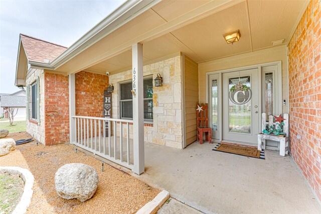 6367 Bridle Trl, Caddo Mills, TX 75135 - entrance to property with a porch, brick siding, a shingled roof, and stone siding