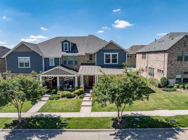 2606 High Cotton Ln, Garland, TX 75042 - craftsman house with board and batten siding, a porch, a front yard, and a shingled roof