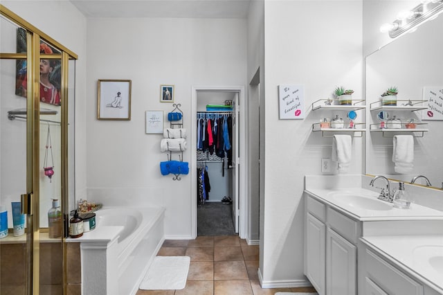 4503 Aspen Glen Rd, Plano, TX 75024 - full bathroom with vanity, tile patterned floors, a garden tub, a spacious closet, and baseboards