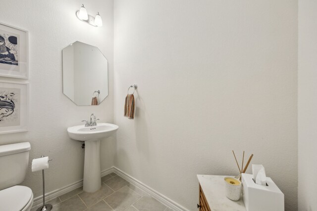 2812 Quill Ln, Northlake, TX 76247 - bathroom featuring toilet, tile patterned flooring, and baseboards