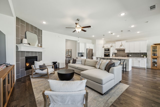 2812 Quill Ln, Northlake, TX 76247 - living area with a ceiling fan, a tile fireplace, dark wood-style flooring, and recessed lighting