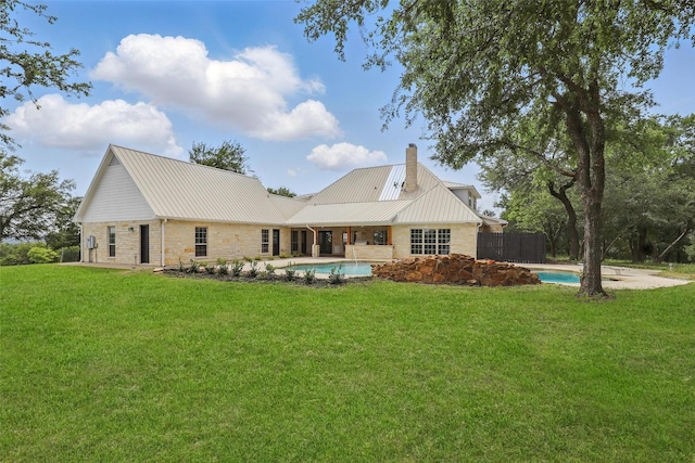 1430 Black Hawk Trl, Nemo, TX 76070 - rear view of house with stone siding, a chimney, an outdoor pool, and a lawn
