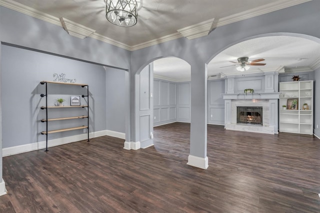 4109 Twin Falls St, Irving, TX 75062 - unfurnished living room with arched walkways, a ceiling fan, wood finished floors, crown molding, and a lit fireplace