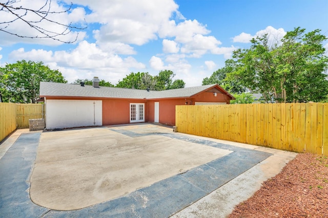 4109 Twin Falls St, Irving, TX 75062 - view of front facade with french doors, a patio area, a fenced backyard, and a shingled roof