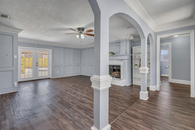 4109 Twin Falls St, Irving, TX 75062 - unfurnished living room with a ceiling fan, plenty of natural light, ornamental molding, dark wood-style floors, and a fireplace with raised hearth