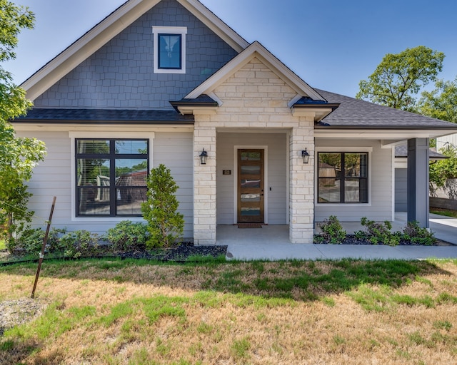 513 Dillon St, Waxahachie, TX 75165 - view of front of house with a front lawn, roof with shingles, and stone siding