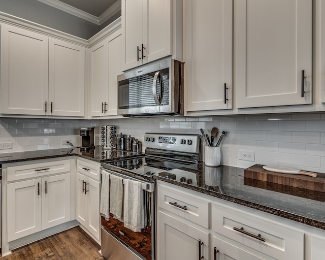 513 Dillon St, Waxahachie, TX 75165 - kitchen with stainless steel appliances, crown molding, white cabinets, dark stone countertops, and decorative backsplash