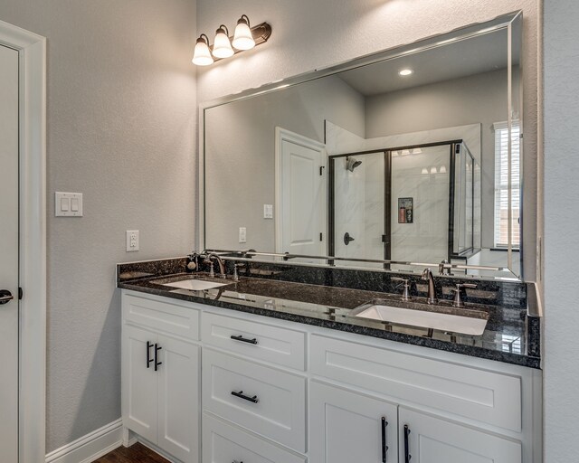 513 Dillon St, Waxahachie, TX 75165 - full bathroom featuring a shower stall, double vanity, and a textured wall