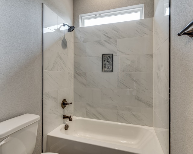 513 Dillon St, Waxahachie, TX 75165 - bathroom featuring toilet, tub / shower combination, and a textured wall