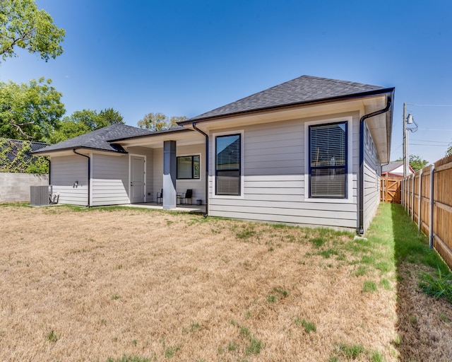 513 Dillon St, Waxahachie, TX 75165 - rear view of property with central AC, a shingled roof, and a patio