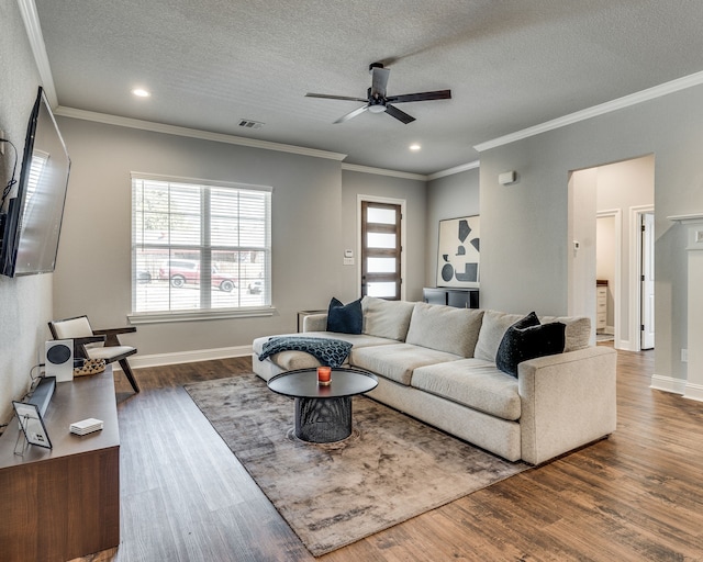 513 Dillon St, Waxahachie, TX 75165 - living room featuring a ceiling fan, plenty of natural light, wood finished floors, a textured ceiling, and crown molding