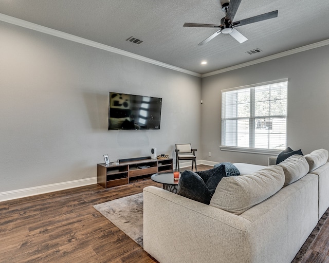 513 Dillon St, Waxahachie, TX 75165 - living room with dark wood-type flooring, baseboards, ornamental molding, a textured ceiling, and ceiling fan