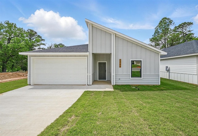 2734 W Washington St, Denison, TX 75020 - mid-century modern home with board and batten siding, a front yard, driveway, and a garage