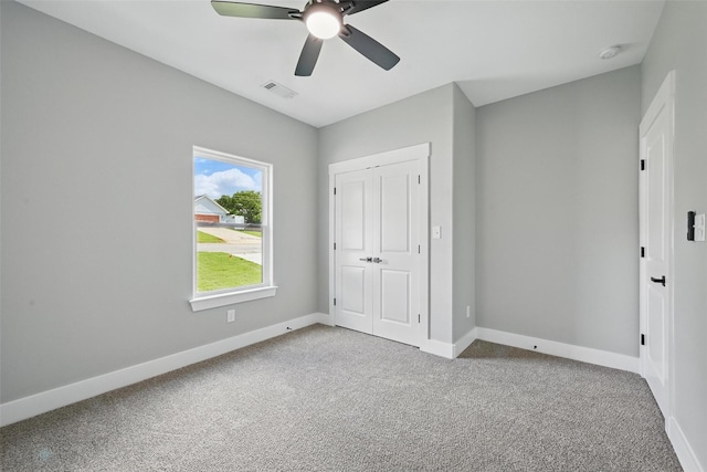 2734 W Washington St, Denison, TX 75020 - unfurnished bedroom with carpet, baseboards, and a closet