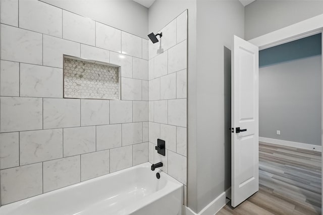 2734 W Washington St, Denison, TX 75020 - full bathroom with  shower combination, wood finished floors, and baseboards