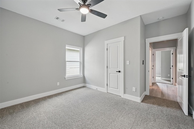 2734 W Washington St, Denison, TX 75020 - unfurnished bedroom with carpet floors, baseboards, and a ceiling fan