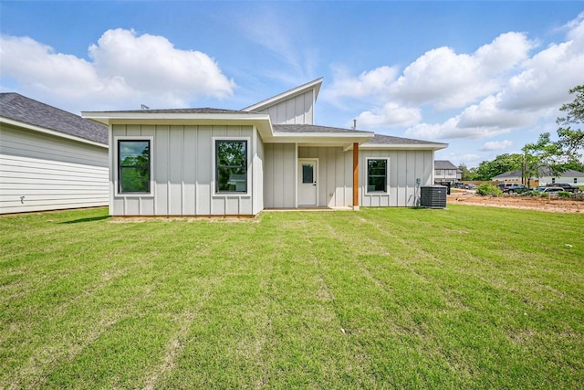 2734 W Washington St, Denison, TX 75020 - back of house with board and batten siding, a yard, and cooling unit