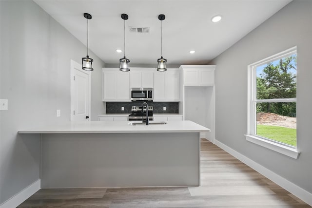2734 W Washington St, Denison, TX 75020 - kitchen with stainless steel appliances, plenty of natural light, backsplash, light countertops, and recessed lighting