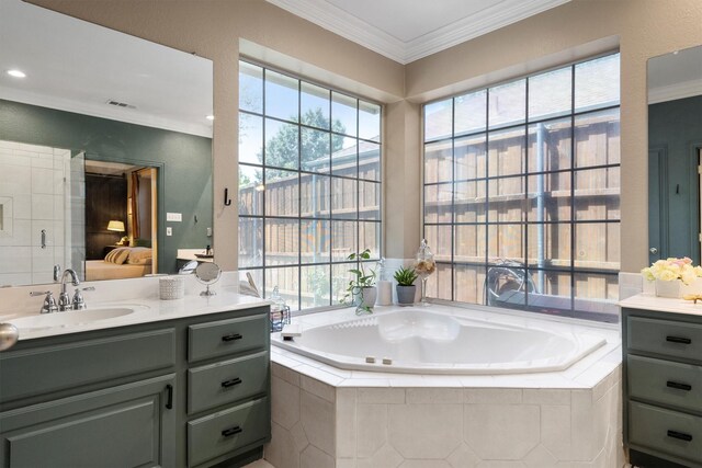 ensuite bathroom with vanity, a bath, and ornamental molding