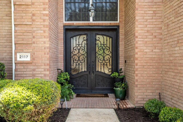 doorway to property with french doors and brick siding