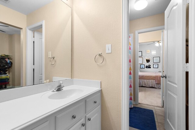 bathroom with ceiling fan, vanity, and tile patterned flooring