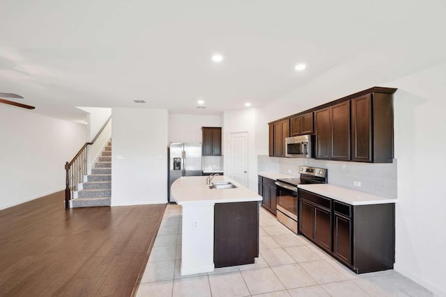 107 Mesa Verde Ct, Forney, TX 75126 - kitchen featuring stainless steel appliances, a sink, backsplash, light countertops, and recessed lighting