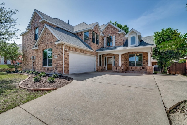 5504 Seneca Dr, Plano, TX 75094 - view of front of home featuring brick siding, driveway, a shingled roof, and fence