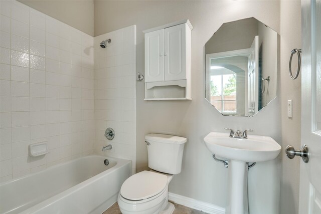 5504 Seneca Dr, Plano, TX 75094 - bathroom featuring toilet,  shower combination, baseboards, and a sink