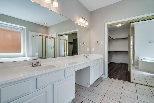 5504 Seneca Dr, Plano, TX 75094 - bathroom with tile patterned floors, a stall shower, a garden tub, double vanity, and a spacious closet