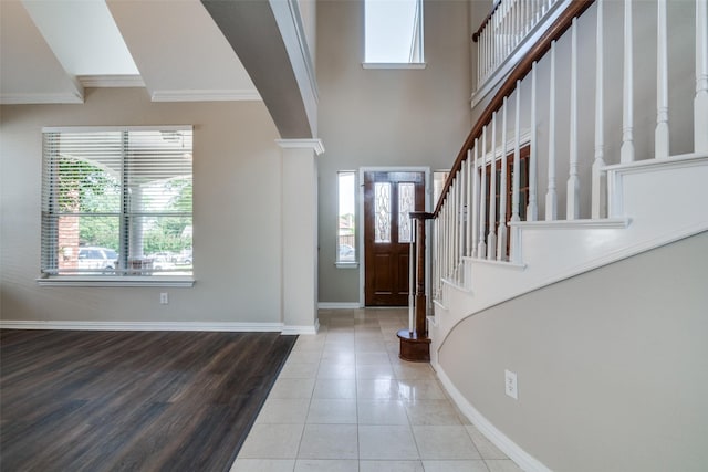 5504 Seneca Dr, Plano, TX 75094 - entryway featuring ornamental molding, plenty of natural light, baseboards, stairway, and tile patterned flooring