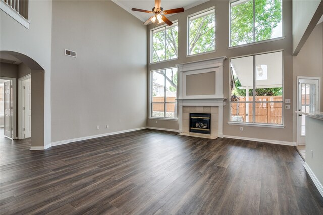 5504 Seneca Dr, Plano, TX 75094 - unfurnished living room featuring high vaulted ceiling, a ceiling fan, dark wood finished floors, baseboards, and arched walkways