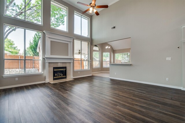 5504 Seneca Dr, Plano, TX 75094 - unfurnished living room with ceiling fan, healthy amount of natural light, dark wood-style floors, and a high ceiling