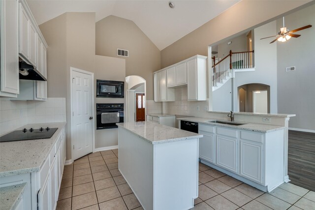 5504 Seneca Dr, Plano, TX 75094 - kitchen with black appliances, arched walkways, a sink, a ceiling fan, and a kitchen island