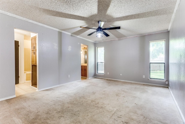 104 NE Rosamond St, Burleson, TX 76028 - unfurnished bedroom with ornamental molding, ensuite bath, light carpet, ceiling fan, and a textured ceiling
