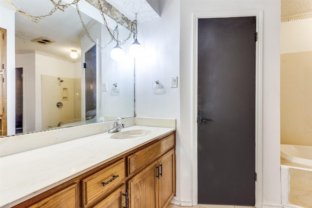 104 NE Rosamond St, Burleson, TX 76028 - bathroom with a textured ceiling, vanity, and ornamental molding
