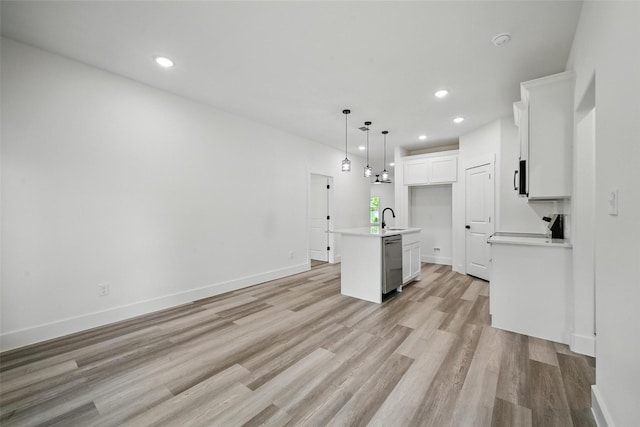 912 Layne Dr, Denison, TX 75020 - kitchen with stainless steel dishwasher, a sink, light wood-style floors, white cabinetry, and recessed lighting