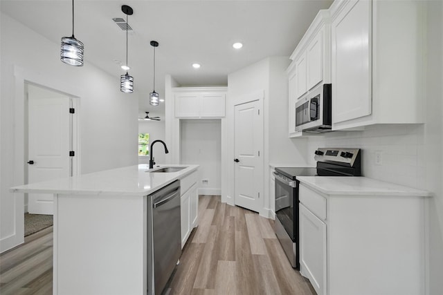 912 Layne Dr, Denison, TX 75020 - kitchen featuring appliances with stainless steel finishes, a sink, light wood-type flooring, white cabinets, and recessed lighting